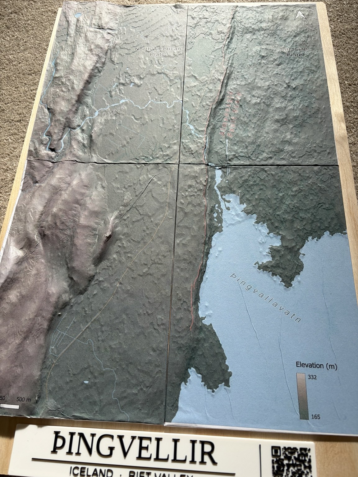 Close angled view of the Þingvellir terrain, showing the printed map following the rift relief and the visible tile joins.